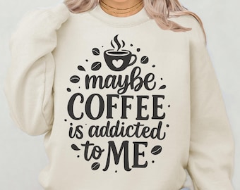 May include: A cream colored sweatshirt with a black graphic that says "maybe coffee is addicted to me" with a coffee cup and coffee beans surrounding the text.