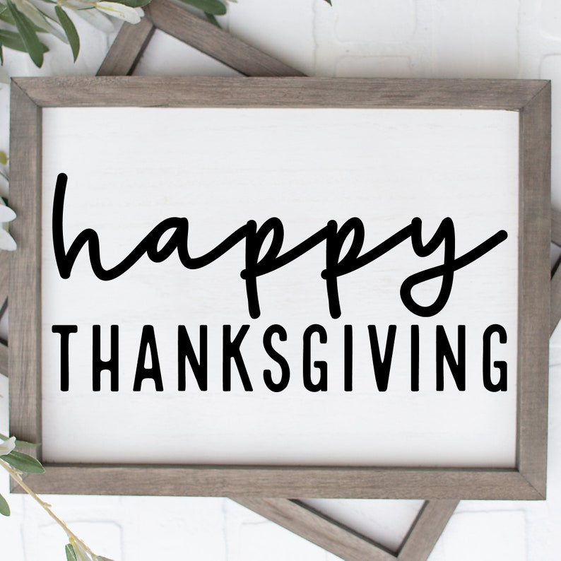 May include: A framed sign with the text "happy thanksgiving" in black script font on a white background.