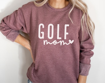 May include: A maroon sweatshirt with the text "GOLF mom" in white with a small white heart.
