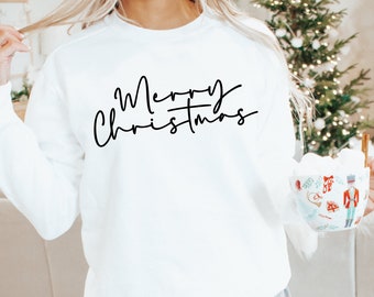 May include: White sweatshirt with black text that reads "Merry Christmas" in a cursive font.