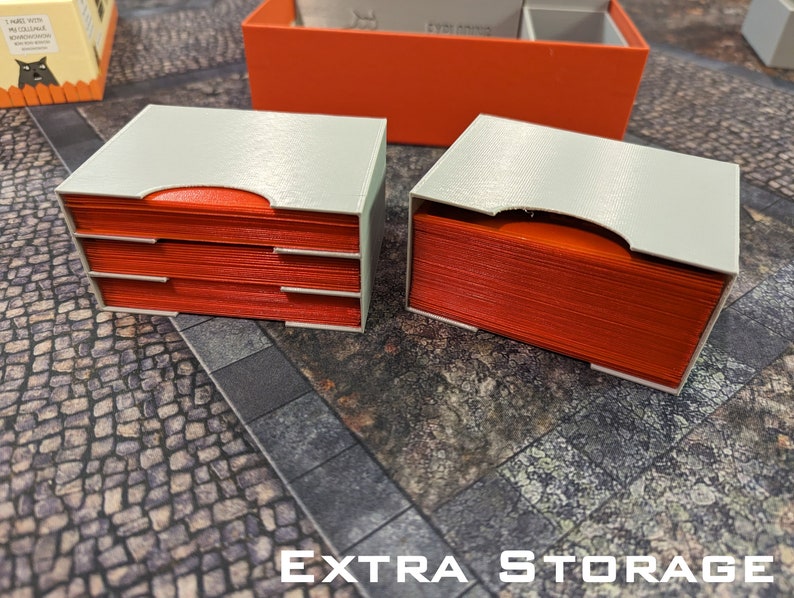 May include: Two white storage boxes with red card inserts. The boxes are labelled "EXTRA STORAGE".