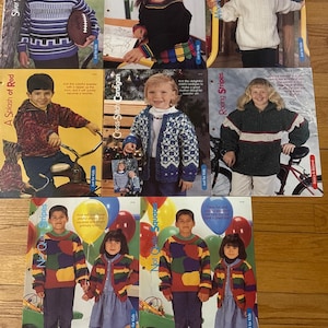 May include: A collection of knitting patterns for children's sweaters. The patterns feature a variety of colorful designs, including stripes, cables, and squares. The patterns are titled "Silver Streak Pullover", "A Splash of Red", "Cross-Stitch Cardigan", "Crayon Time", "Not Quite Stripes", "Not Quite Squares", "Roaring Stripes", and "More Cables for Kids".