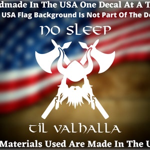 May include: White vinyl decal featuring a Viking helmet with crossed axes. The text "NO SLEEP TIL VALHALLA" is beneath the image. The decal is displayed against a blurred American flag background.
