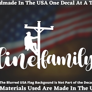 May include: White decal featuring a lineman climbing a utility pole, with the word "linefamily" in cursive script. The background is a blurred American flag. Text at the top reads "Handmade In The USA One Decal At A Time."
