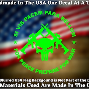 May include: Green vinyl decal with a skull and crossbones design. The skull is a stylized Punisher skull. The crossbones are two rifles crossed over each other. The decal is surrounded by a circle with the text "Si Vis Pacem Para Bellum" and "For Peace Prepare For War".
