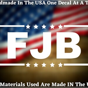 May include: White decal featuring the letters "FJB" in a bold typeface, enclosed by a white border and six white stars. The decal is set against a blurred backdrop of an American flag.