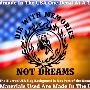 May include: Black decal featuring a Grim Reaper figure within a flaming circle, with the words "DIE WITH MEMORIES NOT DREAMS." The background is a blurred American flag. Text at the top reads "Handmade In The USA One Decal At A Time."