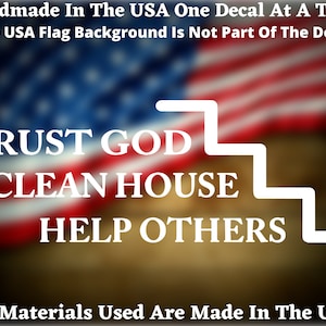 May include: White vinyl decal with the text "TRUST GOD CLEAN HOUSE HELP OTHERS" in a white stair-step design. The decal is on a blurred background of the American flag.