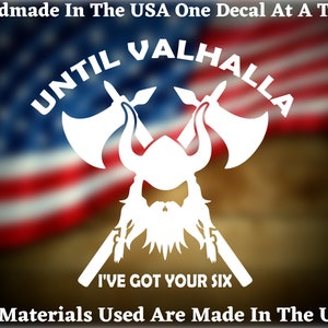 May include: White vinyl decal featuring a Viking helmet, crossed axes, and the text "Until Valhalla I've Got Your Six". The decal is set against a blurred American flag background.