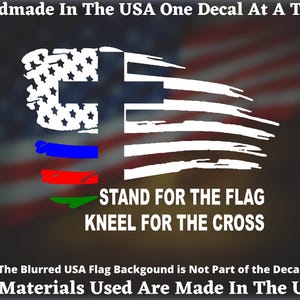 May include: White decal with a design of the American flag and a cross, with blue, red, and green stripes. Text reads "STAND FOR THE FLAG, KNEEL FOR THE CROSS." Additional text states "Handmade In The USA" and "All Materials Used Are Made In The USA."