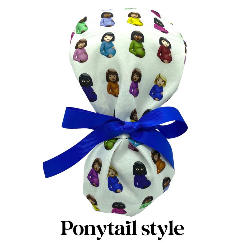 May include: White ponytail style scrub cap with a blue ribbon. The cap is patterned with colorful illustrations of pregnant figures. The text "Ponytail style" is printed in black at the bottom of the image.