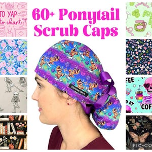 May include: A collection of ponytail scrub caps featuring various patterns including dinosaurs, skeletons, floral prints, and coffee-themed designs. The central cap displays a purple and blue galaxy background with cartoon dinosaurs and disco balls.