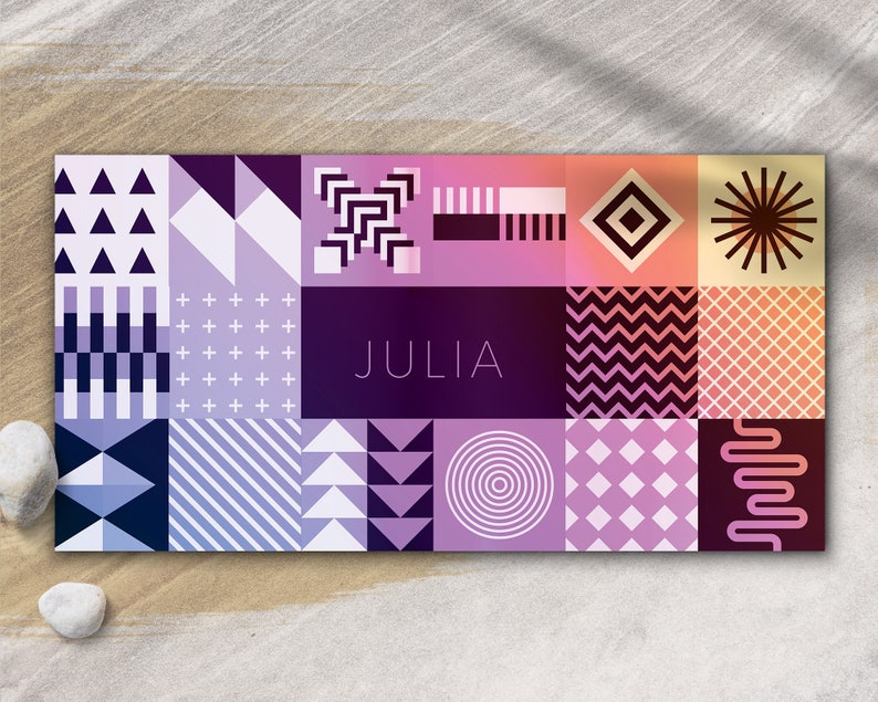 May include: A colorful geometric pattern card with the name "JULIA" in the center. The card features a variety of shapes and colors, including triangles, squares, circles, and stripes.