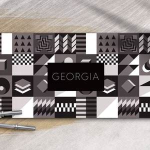 May include: A black and white geometric pattern with the word "GEORGIA" in a black rectangle in the center.