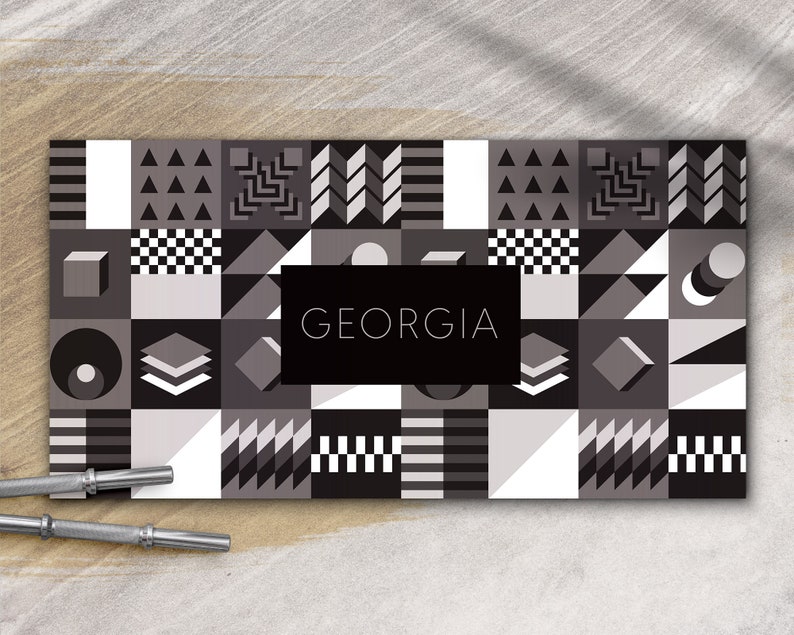 May include: A black and white geometric pattern with the word "GEORGIA" in a black rectangle in the center.