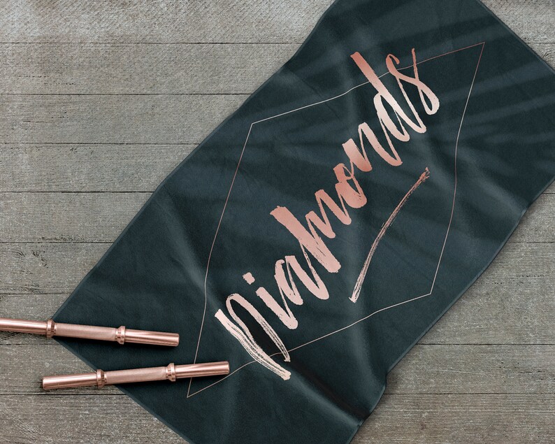 May include: A dark green yoga mat with the word "Diamonds" written in rose gold lettering.