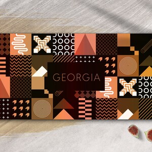 May include: Abstract geometric pattern design in shades of brown, orange, and white with the word "GEORGIA" in white text.