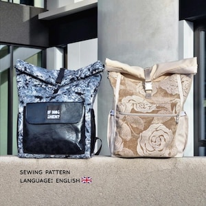 May include: Two backpacks. One is patterned with black and white swirls, with a black front pocket that reads "IF NOT THEN?". The other is beige with a floral rose pattern. Both have adjustable straps and metal buckles.