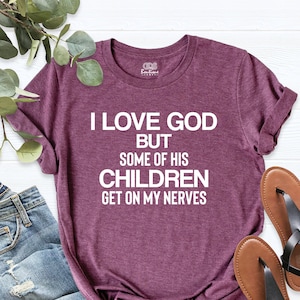 May include: A maroon t-shirt with the text "I love God but some of his children get on my nerves".