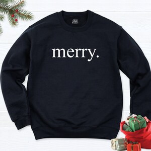 May include: Black sweatshirt with the word "merry." printed in white on the front.