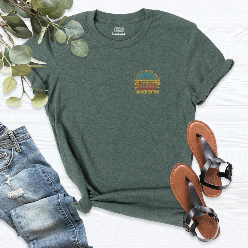 May include: A dark green t-shirt with a vintage-style graphic that says "45 Years of Being Awesome 1975 Limited Edition".