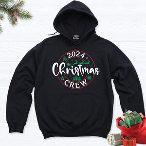May include: Black hooded sweatshirt with a red and green circle graphic that says "2024 Christmas Crew".
