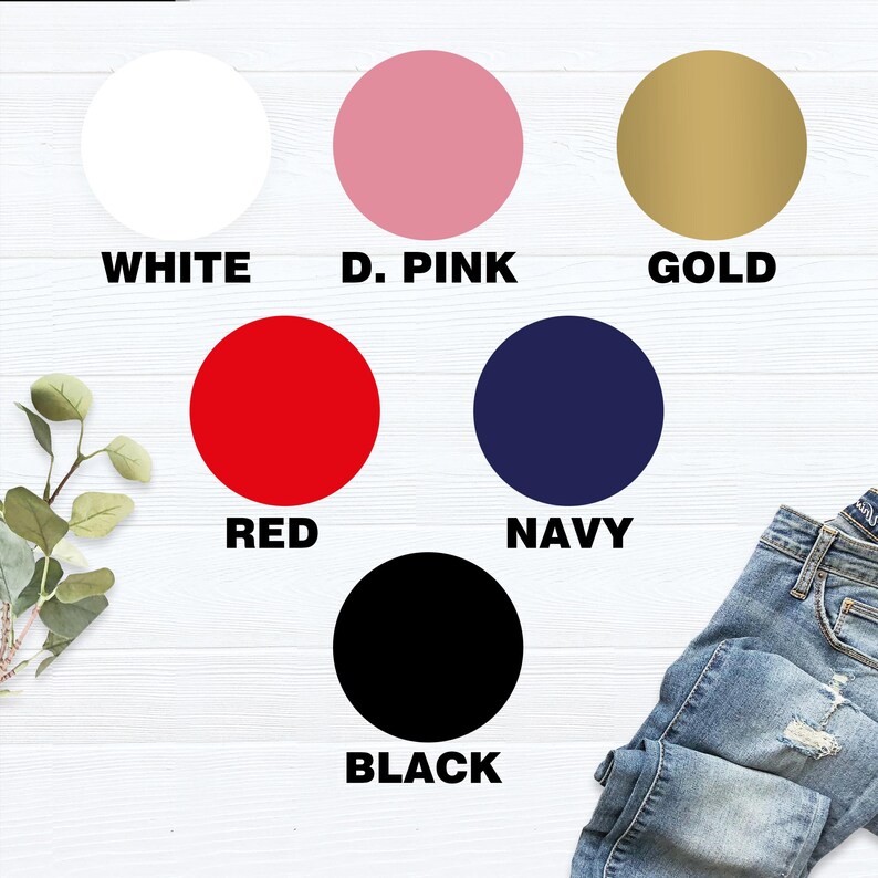 May include: A color chart featuring six circular color swatches: white, D. Pink, gold, red, navy, and black. Each color is labeled with its name in bold, uppercase letters. A pair of blue jeans is visible in the bottom right corner.