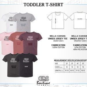 May include: Toddler T-shirt size chart with color options. The chart shows a variety of colors including white, light grey heather, pink, heather mauve, heather maroon, dark grey heather, and black. The chart also includes a measurement specification report with sizes 2T, 3T, 4T, and 5T. The chart shows the chest and length measurements in inches.