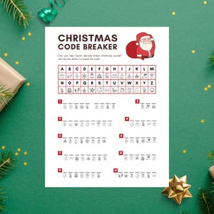 May include: A white Christmas Code Breaker game sheet featuring a Santa Claus illustration. The sheet has a key to decode Christmas words, with numbered puzzles and symbols. The text reads, "CHRISTMAS CODE BREAKER".