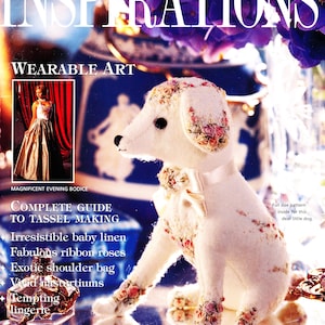 May include: A magazine cover featuring a white embroidered dog with pink and white flowers. The magazine title is "Inspirations Wearable Art" and the text "Complete Guide to Tassel Making" is also visible.