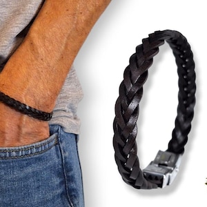 Puede incluir: Pulsera trenzada de cuero marrón oscuro con cierre plateado. La pulsera se muestra en una muñeca y por separado. Un accesorio elegante, de diseño clásico.