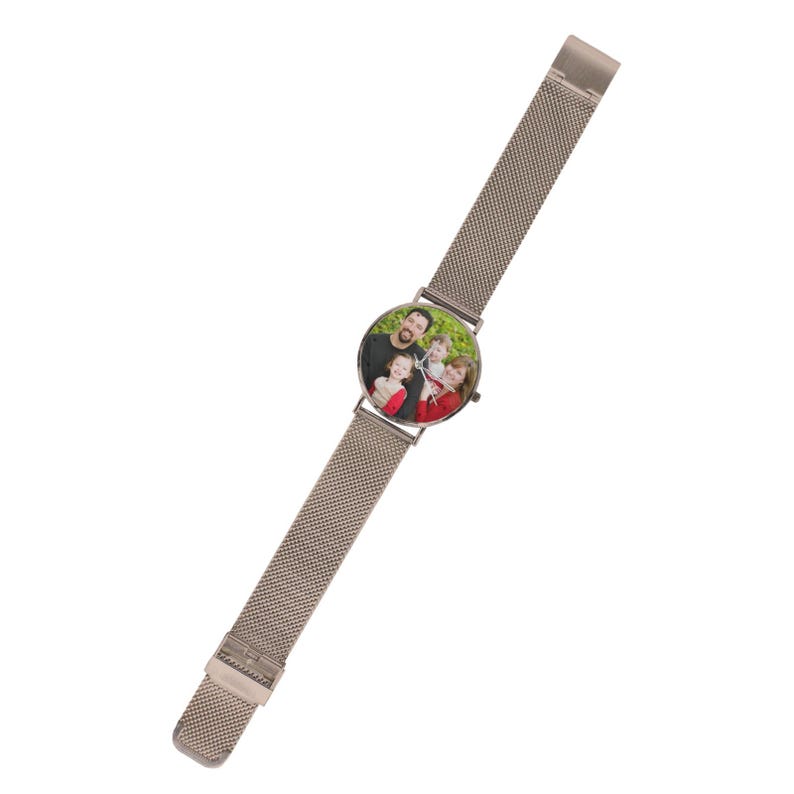 May include: A wristwatch with a metallic silver mesh strap and a round face. The watch dial features a colour photograph of a family of three, including an adult and two children, with thin silver hands indicating the time over the image.