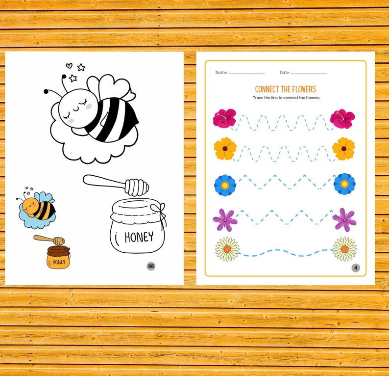 May include: A black and white line drawing of a bee sleeping in a cloud. Below the bee is a jar of honey with a dipper. The text "HONEY" is written on the jar. A printable worksheet with a bee and honey theme.