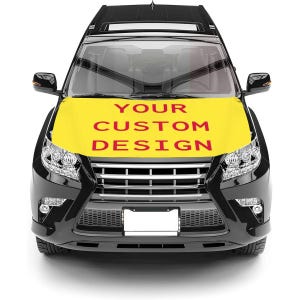 May include: A white ceramic mug with a black handle and the text "But First, Coffee" in a bold, black font. The mug is set against a blurred background, suggesting a cozy setting.