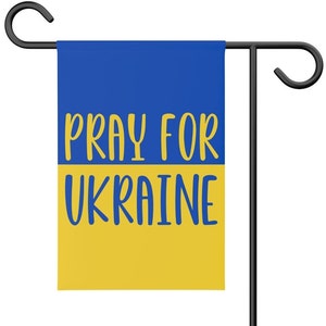 May include: A blue and yellow garden flag with the text "Pray for Ukraine".