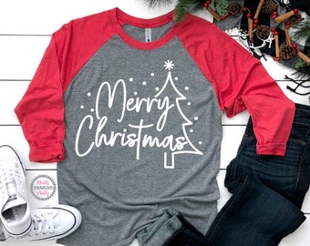 May include: A gray and red long-sleeved shirt with a white design of a Christmas tree and the text "Merry Christmas".