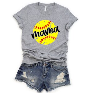 May include: Gray t-shirt with a yellow softball graphic and the word "mama" in black lettering.
