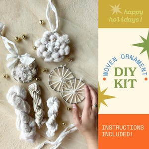 May include: A DIY woven ornament kit with instructions included. The kit includes white yarn, woven ornaments, and small gold bells. The text "happy holidays!" and "woven ornament DIY kit" are visible.