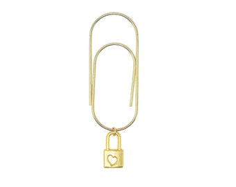 May include: A gold paper clip with a small gold padlock charm with a heart cut-out.
