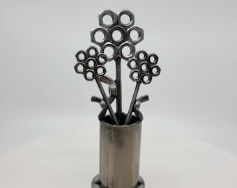 Metal vase with three nuts and bolts style welded flowers