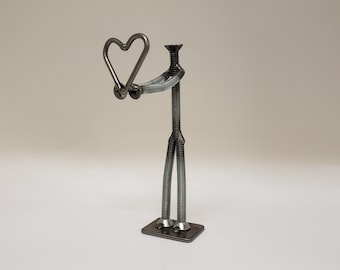 Welded nuts and bolts style figure holding heart