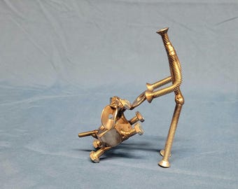Welded metal nuts and bolts dog playing tug of war with frisbee