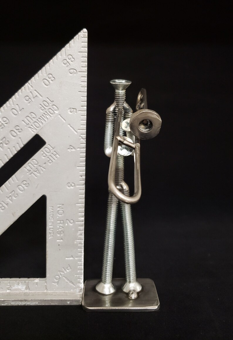 Welded metal nuts and bolts trombone player