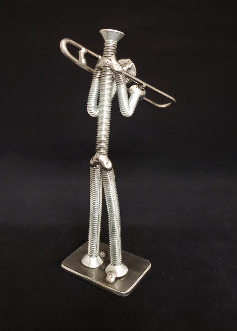 Welded metal nuts and bolts trombone player