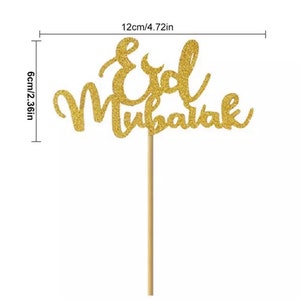 May include: Gold glitter cake topper with the words "Eid Mubarak" on a wooden stick. The topper is 4.72 inches wide and 2.36 inches tall.