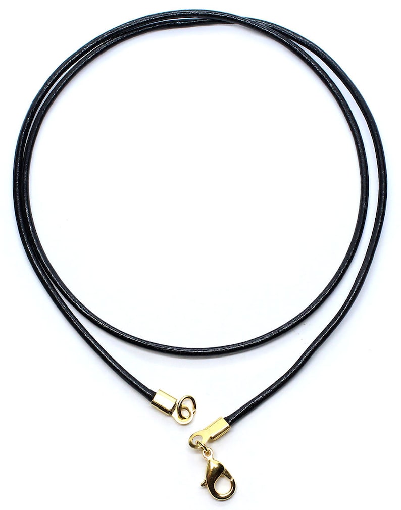 May include: A black leather cord necklace with a gold clasp. The cord is approximately 20 inches long.