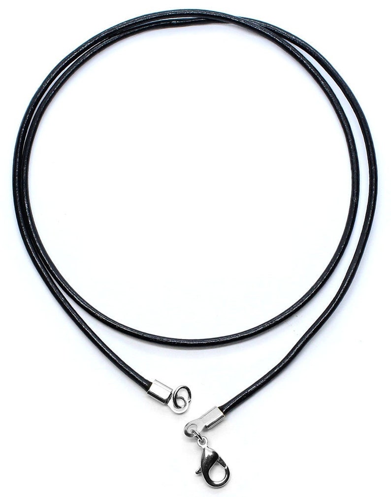 May include: A black leather cord necklace with a silver clasp.