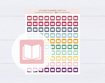 May include: A sticker sheet featuring rows of small square icons, each displaying a white open book graphic. The stickers are arranged in a rainbow colour gradient, including red, blue, green, yellow, pink, and purple. Text at the top reads STICKER PLANNER SHOP CO.