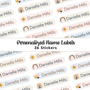 May include: A collection of 36 rectangular personalised name labels featuring the text Danielle Mills. The stickers are arranged in rows and include various pastel-coloured icons such as rainbows, suns, and hearts on light blue, pink, and cream backgrounds.