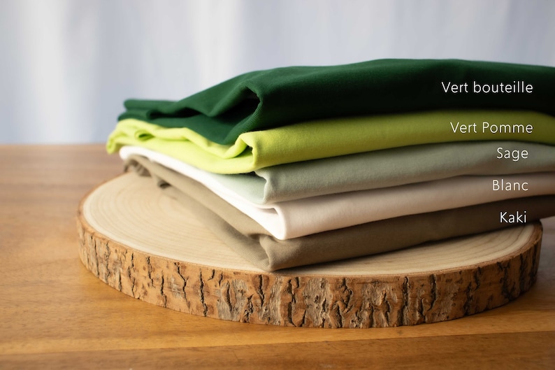 May include: Stack of five fabric swatches in different shades of green, sage, white, and khaki. The swatches are labeled "Vert bouteille", "Vert Pomme", "Sage", "Blanc", and "Kaki".